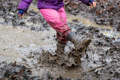 Low section of girl playing in mud