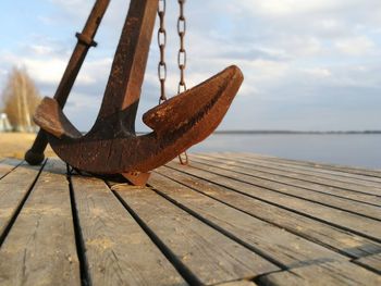 Close-up of rusty pier against sky