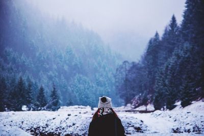 Close-up of person on snow covered landscape