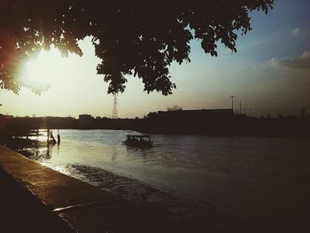 Scenic view of river against sky at sunset