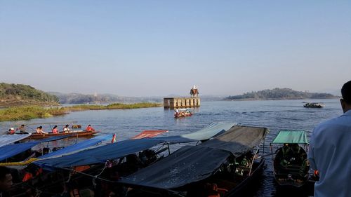 People on boat against clear sky