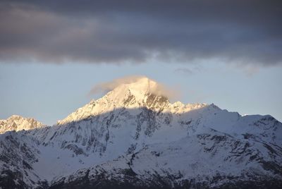 Scenic view of mountains against cloudy sky