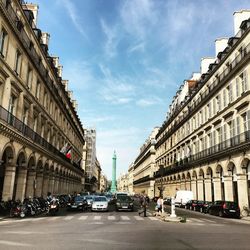 View of city street and buildings against sky