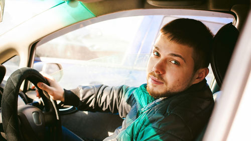 Portrait of man sitting in car