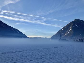 Scenic view of snowcapped mountains against sky