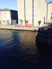 Boats in canal with buildings in background
