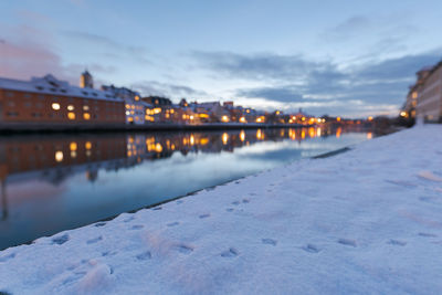 Surface level of river against sky during winter