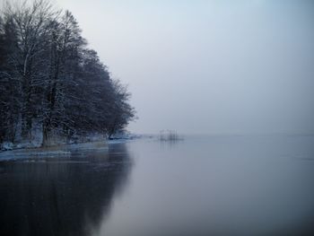 Scenic view of lake against clear sky during winter