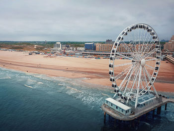 Aerial cityscape of the ferris wheel and the de pier in hague, the netherlands. gloomy day