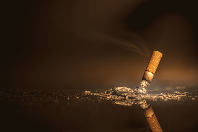 Close-up of cigarette against black background