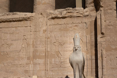 Shadow of old sculpture on wall at temple