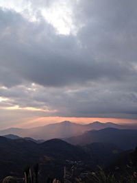 Scenic view of mountains against cloudy sky