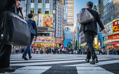 Rear view of people walking on street