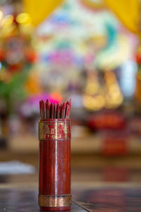 Close-up of wooden sticks on table in temple