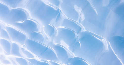 Low angle view of snow against blue sky