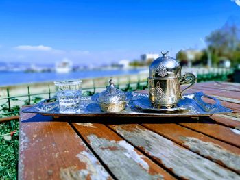Close-up of water on table against blue sky