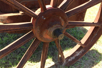 Close-up of rusty wheel on field