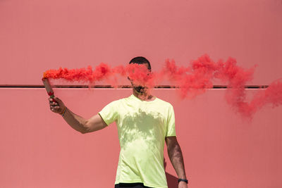 Runner holds a red smoke grenade