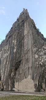 Low angle view of rock formations against sky