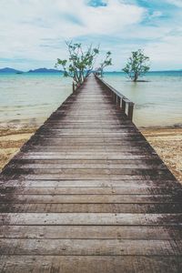 Wooden boardwalk leading towards sea