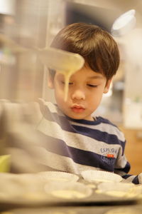 Portrait of boy looking at home