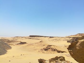 Scenic view of desert against clear blue sky