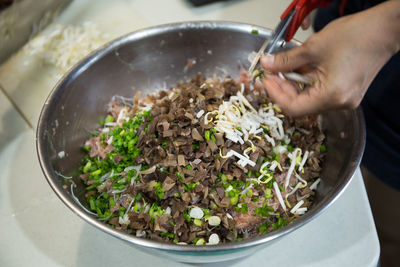 Close-up of person preparing food in bowl