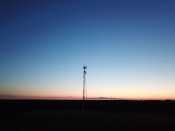 Silhouette landscape against clear sky during sunset