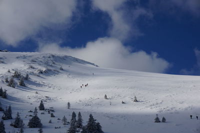 Scenic view of snow covered mountains against sky