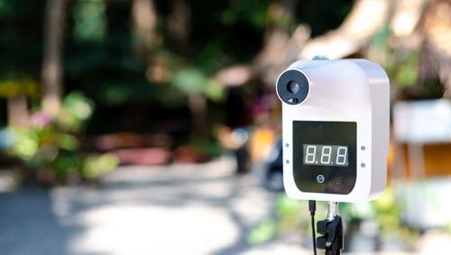 Close-up of telephone booth on road in city