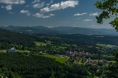 Scenic view of green landscape and mountains against sky