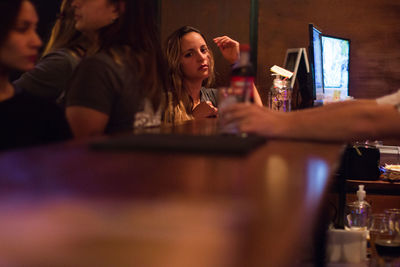 People sitting in restaurant at bar counter