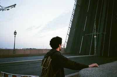 Rear view of man looking against sky