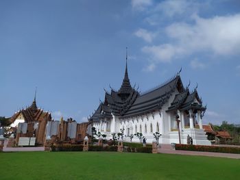 Temple by building against sky