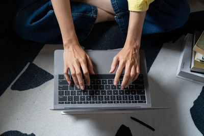 Midsection of woman using laptop