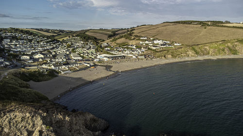 High angle view of townscape by sea against sky