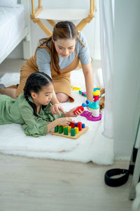 Girl and woman lying on bed