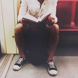 Low section of man sitting on floor