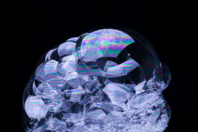 Close-up of bubbles over black background