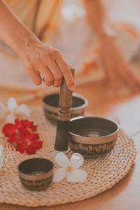 Female hands play meditation on tibetan bowls