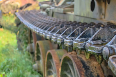 Close-up of abandoned machinery on field