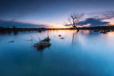 Scenic view of lake against sky during sunset