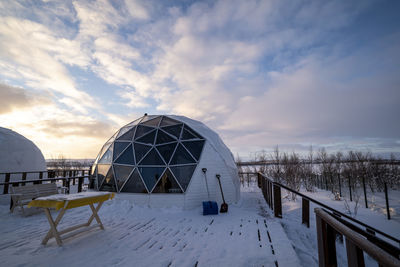 Scenic view of snow covered field against sky