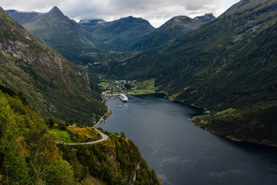 High angle view of river amidst mountains against sky