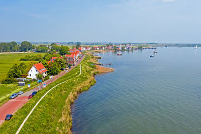 High angle view of sea and buildings against sky