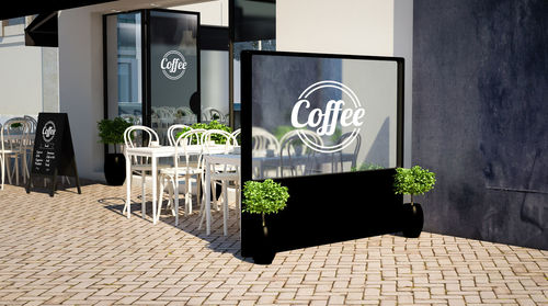 Potted plants on sidewalk against building