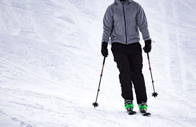 Rear view of person skiing on snowy field