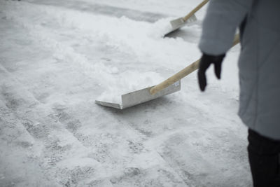 Shovel for snow removal. shovel outside in winter. cleaning track from snowdrifts. snow blockage.