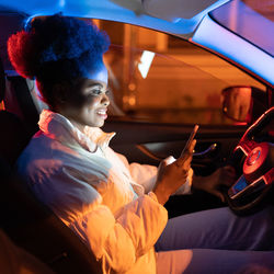 Millennial woman suffer from smartphone addiction, spend day night in social media sit in dark car