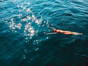 High angle view of woman swimming in sea